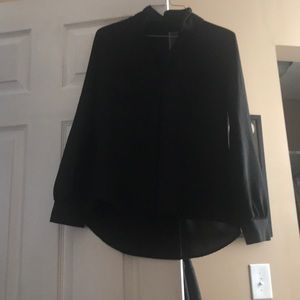 A long sleeve button up black blouse.